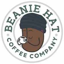 Beanie Hat Coffee Company logo featuring a smiling character in a black beanie sipping coffee, encircled by the brand name in green and gray.